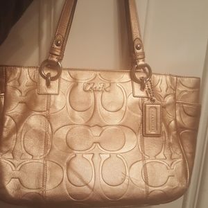 A gold coach purse